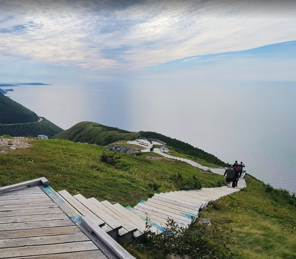 A winding trail leading along green coastal hills